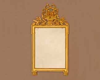 Das Bild zeigt einen klassizistischen Spiegel. Es ist ein Louis-XVI-Spiegel mit wunderbarer Schnitzerei und Vergoldung.